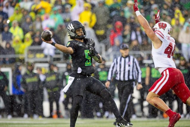 Dante Moore getting off the throw in poor weather (1)